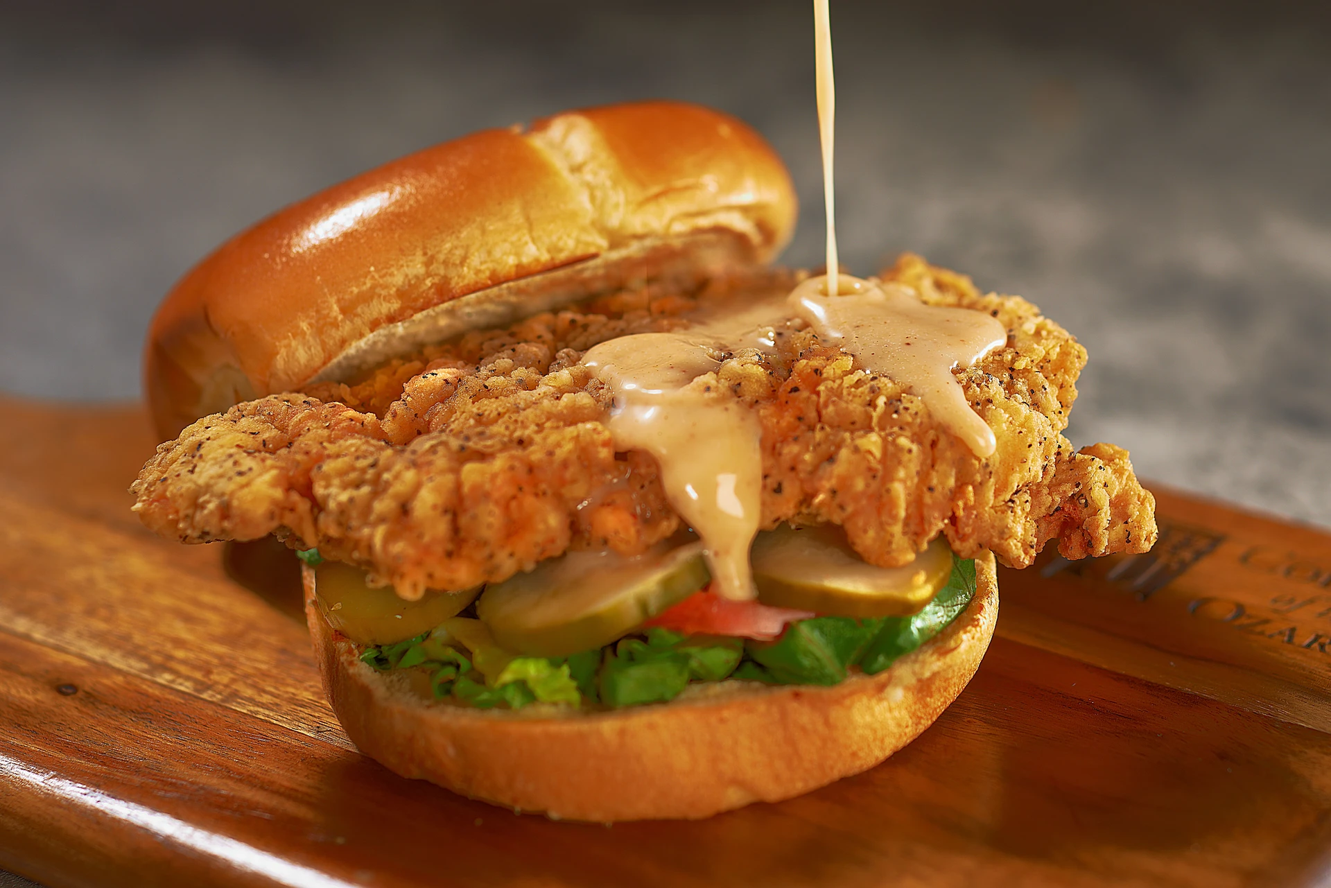 Southern Fried Chicken, Pepper Jelly Aioli, Shredded Lettuce, Tomato, Pickles, and a House-made Brioche Bun